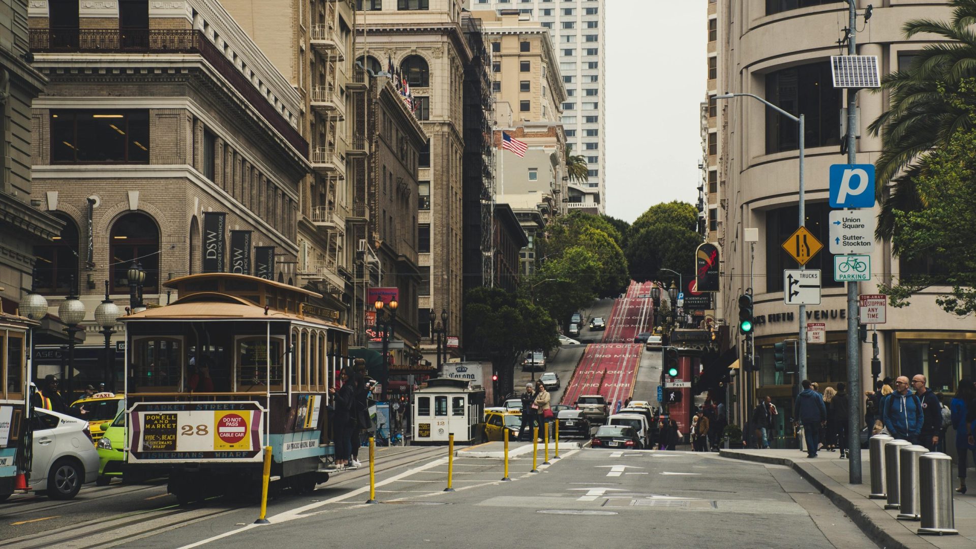 Historic San Francisco street with cable cars and classic architecture. Urban transportation and city life.