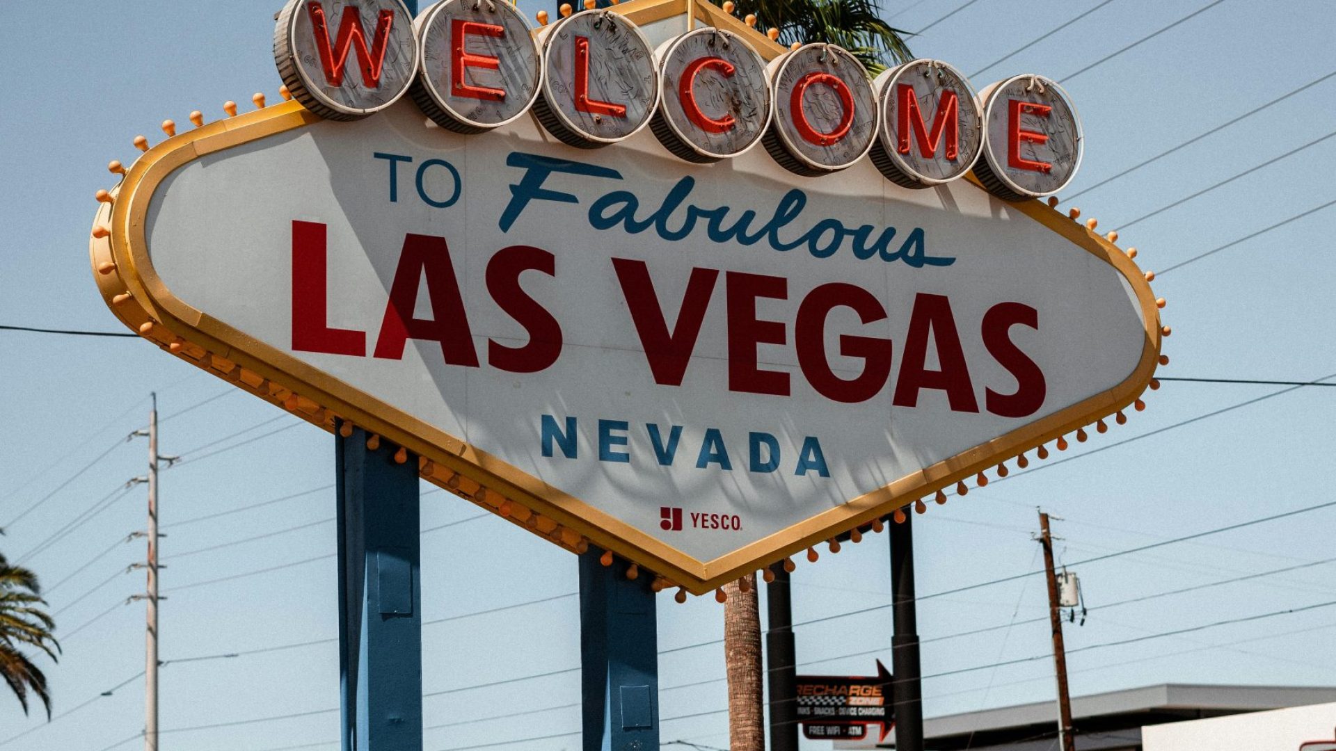 Modern colorful signboard with inscription welcome to fabulous Las Vegas Nevada state in USA placed on green lawn on sunny day
